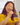 A lady enjoys raw Manuka Honey 346+ MGO in hot herbal tea.